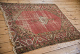 Vintage Malayer rug corner with geometric stylized serrated border and tattered ivory fringe.