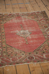 Worn blush pink field, diamond medallion detail, and geometric serrated border on a Malayer rug.