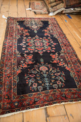 Angled profile of a vintage Sarouk runner emphasizing its deep indigo blue field and traditional floral pattern.
