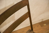 Vintage French cafe chair metal backrest with aged reddish-brown patina.