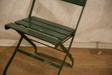 Vintage French cafe chair's dark green metal folding frame with aged finish.