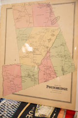 Angled view of the antique 1868 Pound Ridge map, showing its physical form and aged paper.