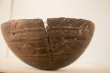Hand-carved vintage wooden African bowl with visible metal repair and geometric patterns.