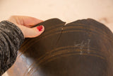 Vintage African wooden bowl with a notable crack and aged dark patina.
