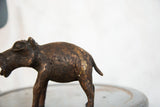 Aged copper hippo sculpture, showing its unique textured surface and tail.