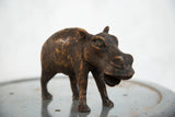 Vintage African copper hippo sculpture, showing its expressive form and aged patina.