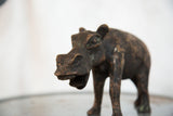 Detailed view of a vintage copper African hippo sculpture's face with textured patina.