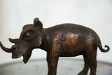 Vintage African copper rhino sculpture body detail, showcasing dark patina and texture.