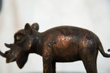 Vintage African copper rhino body, showing rich dark patina and textured metallic surface.