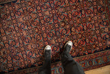 The mostly even, short pile and dense Herati pattern of a hand-knotted antique Bijar rug.