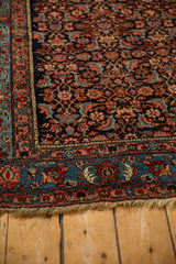 Corner detail of an antique Bijar showing the intricate multi-layered border and secured short fringe.