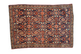 Vintage Tabriz Sennehbaft rug with an oversized Herati motif in teal and red on a navy field.