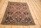 High-angle view of a vintage Persian Tabriz rug, showcasing the full Herati motif and navy blue field.
