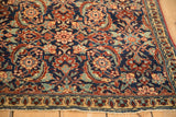 Angled view of the finely woven wool and detailed Herati motif on a vintage Tabriz rug.