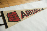 Vintage beige felt pennant displaying black 'ARIZONA' with red Grand Canyon State map.