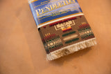 Stacked Pendleton Chief Joseph CoasterRugs featuring vivid southwestern geometric pattern and cream fringe.