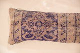 Worn pile texture with faded indigo and beige geometric motifs on a Turkish fragment pillow.