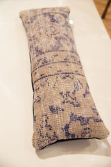 Vintage Turkish rug fragment, distressed beige with indigo geometric pattern, navy velvet side.