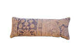 Vintage Turkish rug fragment pillow featuring muted indigo patterns on a beige ground.