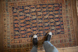 Antique Persian Afshar rug laid flat, showing the scale of its colorful boteh lattice design.