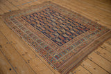 A late 19th-century Afshar collector rug with a repeating boteh design and time-softened colors.