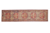 Antique Kerman rug runner with a pictorial column of red medallions depicting mythological figures.