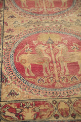 Mythological lion figures within a cochineal red medallion of an antique Persian Kerman rug.