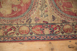 A border cartouche with a rabbit figure beside mythological creatures on an antique Persian runner.