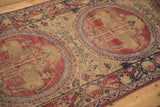 Antique Kerman runner showing red medallions with mythological figures and border cartouches.