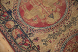 A mythological lion figure inside a cochineal red medallion beside the navy and sand cartouche border.