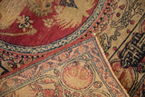 Corner of an antique Kerman rug folded to show the hand-knotted foundation and detailed pile.