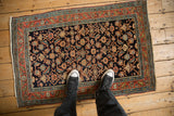 Fine antique Persian Serapi rug with allover Herati design shown for scale.