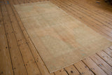 Soft pile texture of a distressed vintage Oushak runner in pale sand and subtle green-blue.