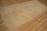 Textured distressed pile of the vintage Oushak runner in pale sand and ocean green.