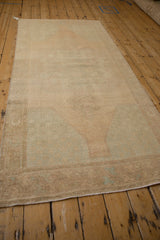 Distressed vintage Oushak runner showing soft pale sand pile and subtle ocean green blue.