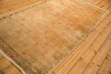The distressed low pile and pale gold color of a vintage Oushak runner seen from an angle.