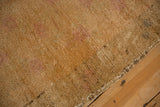Close-up showing the mostly even wear and secured side on a distressed vintage Oushak rug.