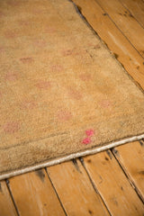 Secured edge and mostly even, worn pile on a vintage distressed Oushak rug runner.