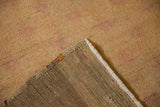The hand-knotted foundation and secured edge of a vintage distressed Oushak rug runner.