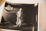 Black and white movie still photograph of a surreal draped figure with skeletal ribcage.