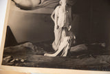Angled black and white vintage photograph, Dali's surreal scene with draped figure.