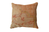 Vintage Turkish Rug Fragment Throw Pillow, muted beige with faded orange geometric design.