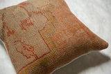 Vintage Turkish rug fragment pillow showing textured weave and subtle patterns.