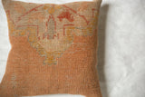 Textured weave of the peachy-orange vintage Turkish rug fragment pillow.