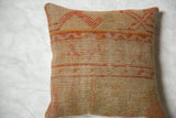 Woven texture and geometric pattern in muted orange and red on vintage Turkish pillow.