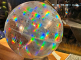 Vibrant rainbow refractions highlighting details on the South America portion of the holographic globe.