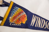 Detailed graphic of a Native American's profile on the textured blue felt pennant.