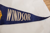 The word WINDSOR in aged, cream-colored lettering on a navy blue felt flag.