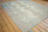 Vintage distressed Oushak carpet showing even wear across the knot heads and floral palmettes.