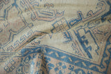Softly distressed pile of a vintage Oushak carpet showing even wear across the knot heads.